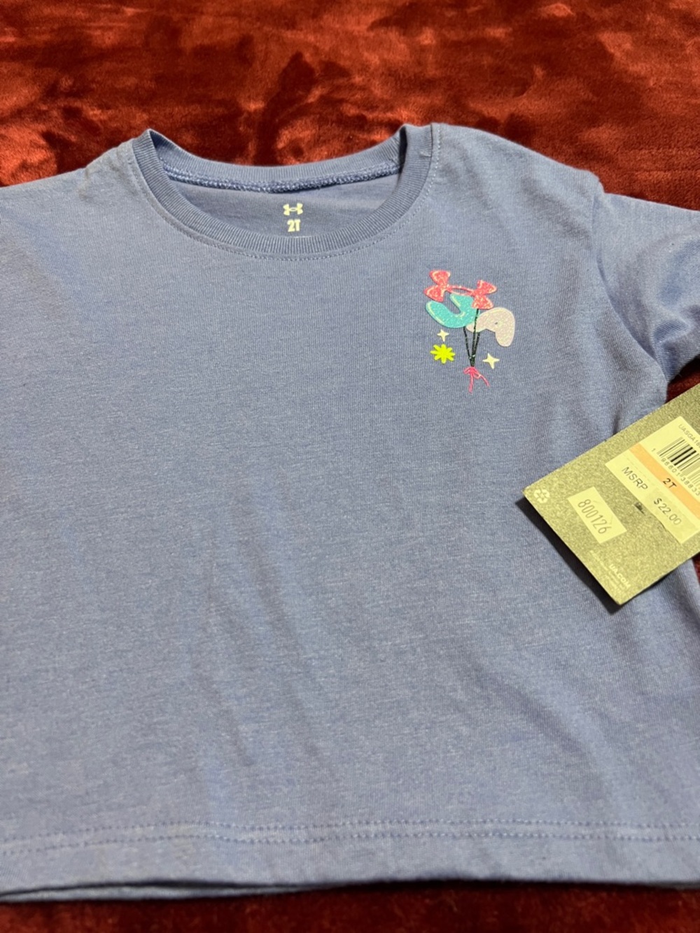 Under Armour Girls' Light Blue Tee with Small Multicolor Chest Graphic